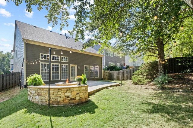 back of property with a lawn and a patio area