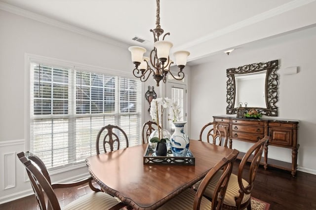 dining room featuring a chandelier, ornamental molding, and dark wood-type flooring