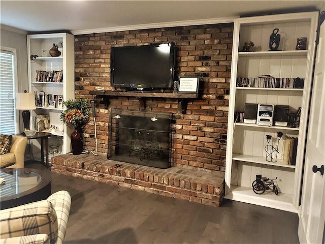 living room featuring a brick fireplace and hardwood / wood-style floors