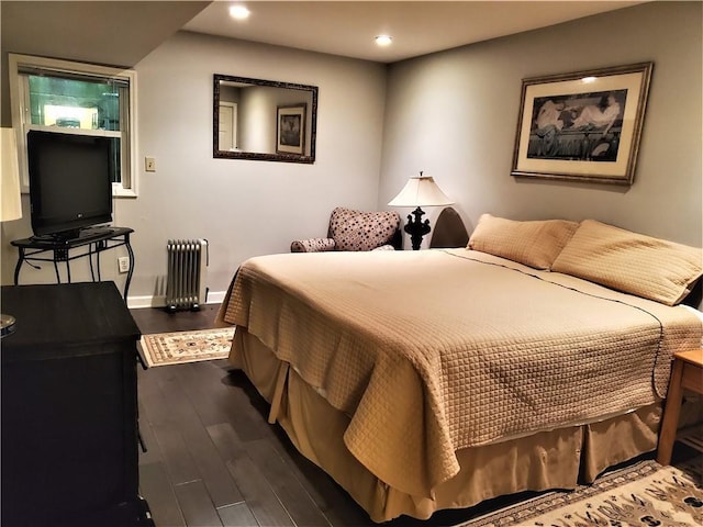 bedroom featuring radiator and dark hardwood / wood-style floors