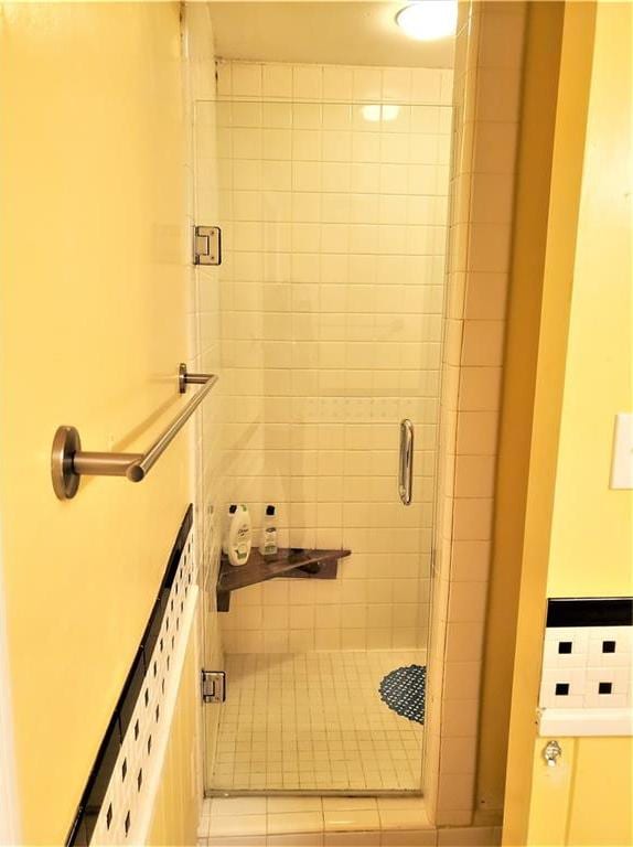 bathroom with walk in shower and tile floors