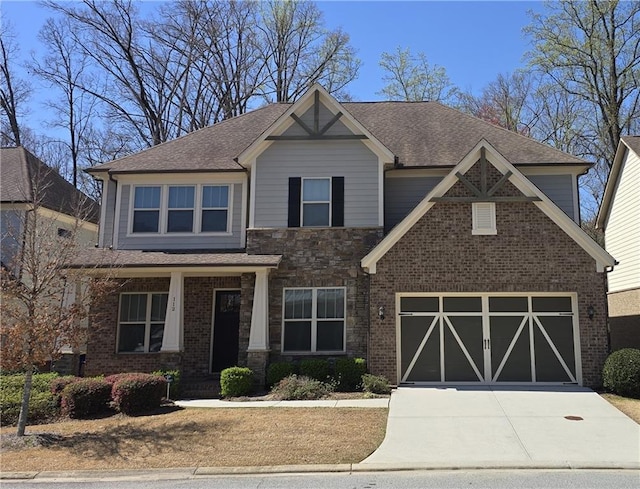 craftsman-style home featuring a garage, brick siding, driveway, and a shingled roof
