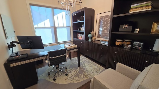 office area with an inviting chandelier and wood finished floors