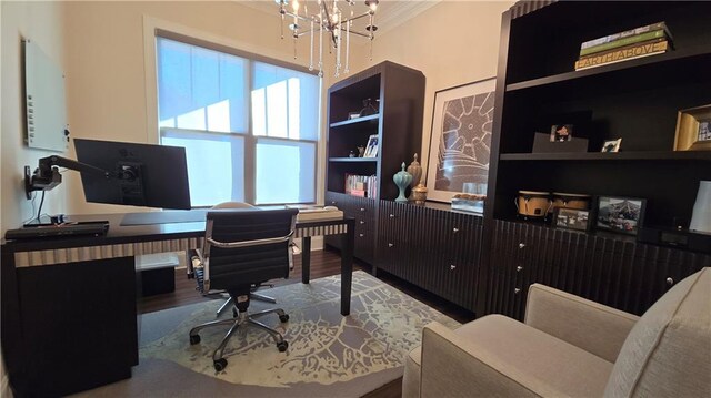 home office with built in features, an inviting chandelier, wood finished floors, and crown molding