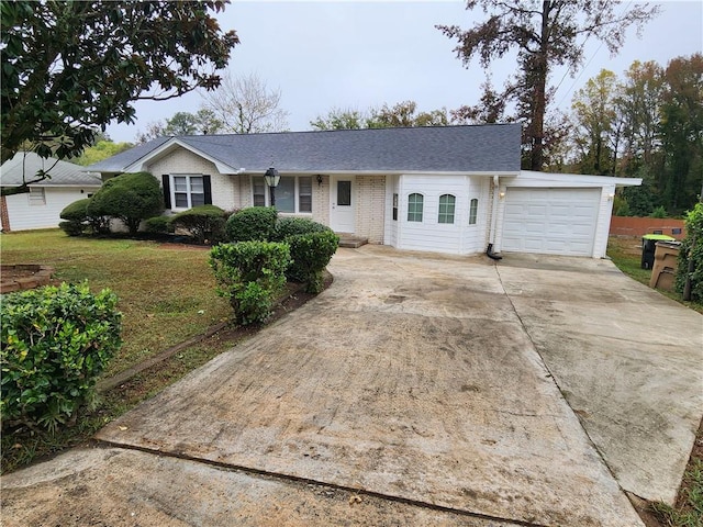 ranch-style home with a front lawn and a garage