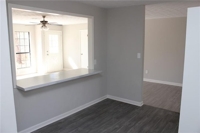 spare room featuring ceiling fan, a textured ceiling, and dark hardwood / wood-style flooring