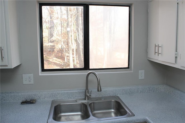 kitchen featuring sink and white cabinets