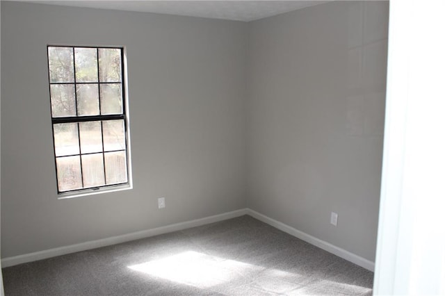 carpeted spare room featuring plenty of natural light