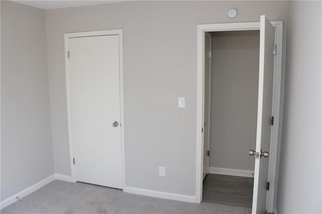 unfurnished bedroom with light colored carpet