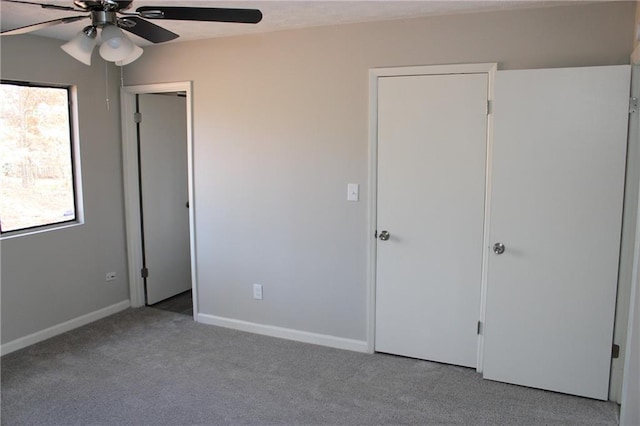 unfurnished bedroom featuring light colored carpet and ceiling fan