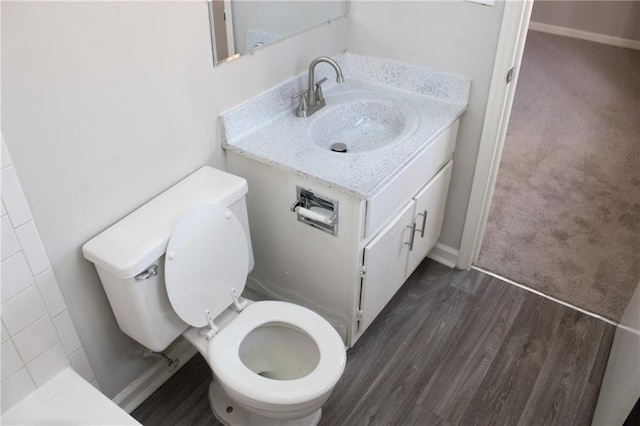 bathroom with vanity, wood-type flooring, and toilet