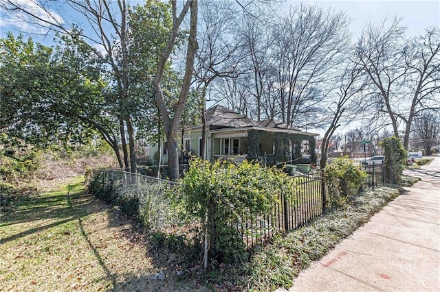 view of property exterior with a fenced front yard