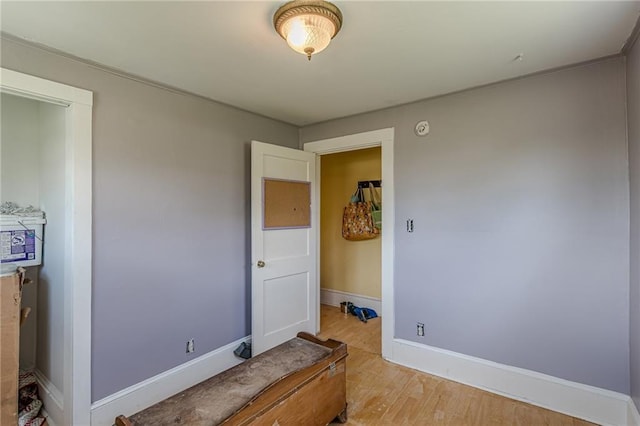 unfurnished bedroom with baseboards and light wood-style floors