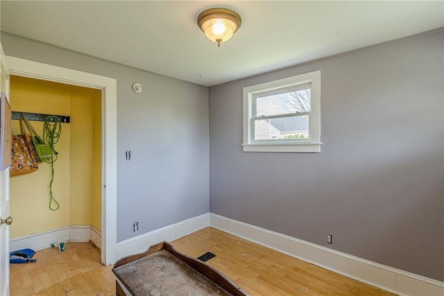 unfurnished room featuring light wood-style flooring and baseboards