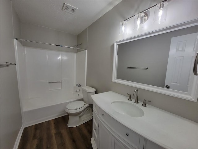 full bathroom featuring toilet, wood-type flooring, bathtub / shower combination, and vanity