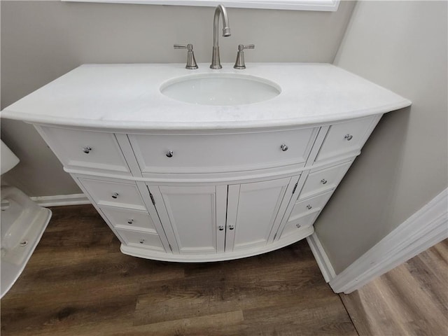 bathroom with vanity and hardwood / wood-style flooring