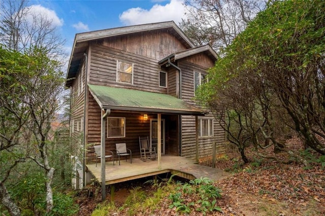 back of house featuring a wooden deck