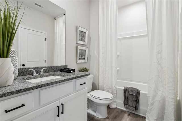 full bathroom with toilet, shower / bath combo with shower curtain, vanity, and hardwood / wood-style flooring