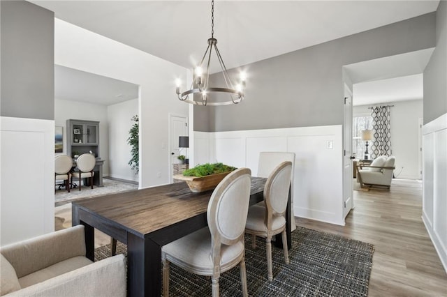 dining area with a chandelier and light hardwood / wood-style flooring