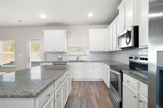 33 N Village Cir, Rydal, GA 30171 - kitchen featuring appliances with stainless steel finishes, white cabinets, decorative backsplash, a center island, and recessed lighting