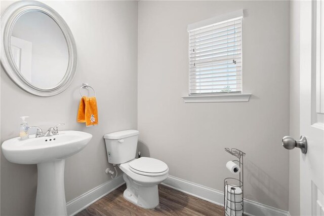 33 N Village Cir, Rydal, GA 30171 - bathroom with baseboards, wood finished floors, toilet, and a sink