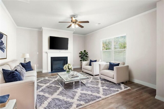 33 N Village Cir, Rydal, GA 30171 - living area featuring crown molding, ceiling fan, wood finished floors, baseboards, and a glass covered fireplace