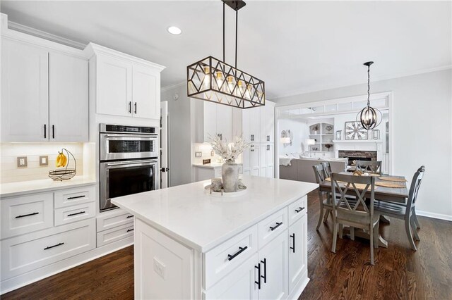 200 Glen Wood Pl, Canton, GA 30114 - kitchen featuring stainless steel double oven, dark wood-style floors, a center island, light countertops, and recessed lighting