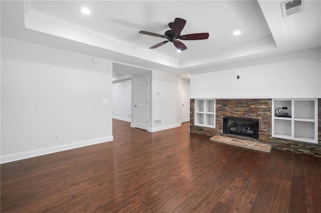 200 Glen Wood Pl, Canton, GA 30114 - unfurnished living room with a tray ceiling, wood-type flooring, a ceiling fan, ornamental molding, and a stone fireplace