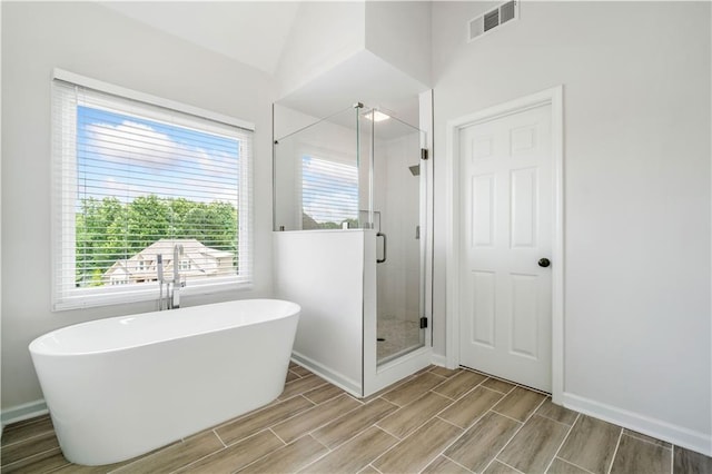 200 Glen Wood Pl, Canton, GA 30114 - full bath with a freestanding tub, a shower stall, wood finish floors, and healthy amount of natural light
