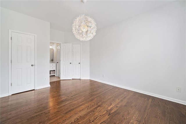 200 Glen Wood Pl, Canton, GA 30114 - spare room with a chandelier and dark wood-style flooring