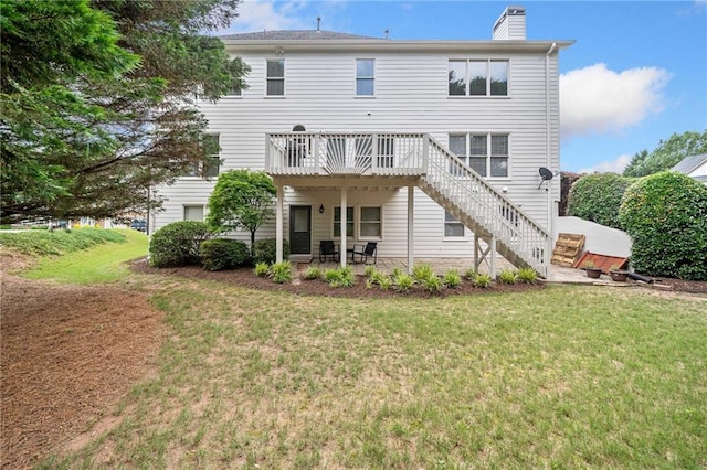 200 Glen Wood Pl, Canton, GA 30114 - rear view of property featuring a deck, a lawn, stairway, and a chimney