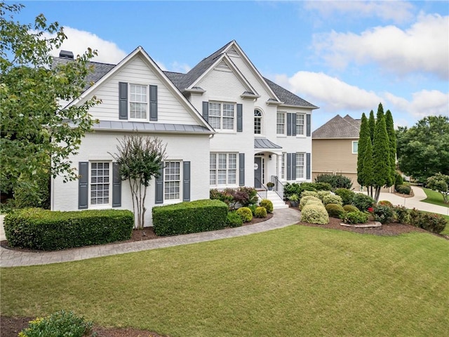 200 Glen Wood Pl, Canton, GA 30114 - view of front of house with a standing seam roof, a front yard, a metal roof, and a chimney
