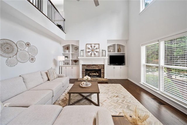 200 Glen Wood Pl, Canton, GA 30114 - living area with a towering ceiling, ceiling fan, dark wood finished floors, and a stone fireplace