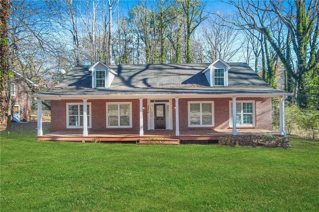 cape cod-style house featuring a front lawn and a porch