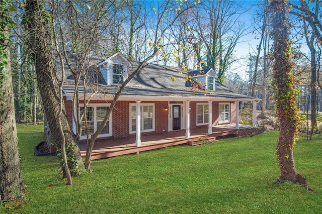 cape cod house with covered porch and a front yard