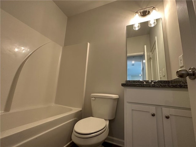 bathroom featuring toilet, vanity, and shower / tub combination