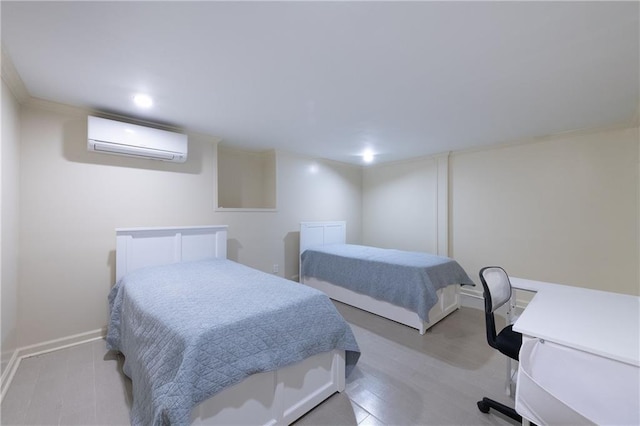 bedroom featuring baseboards, light wood-style flooring, and a wall unit AC