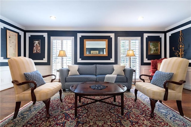 living room with crown molding, wood finished floors, and a healthy amount of sunlight