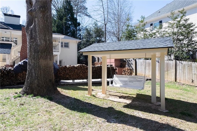 view of yard featuring a carport and fence