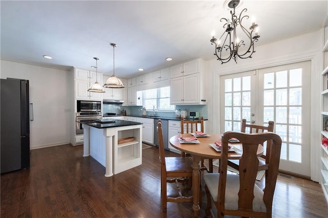 kitchen featuring dark countertops, a sink, french doors, stainless steel appliances, and open shelves