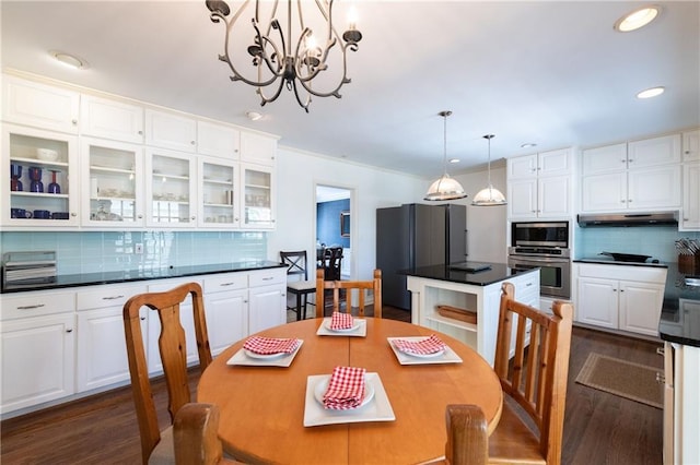 dining space featuring dark wood finished floors, crown molding, recessed lighting, and a chandelier