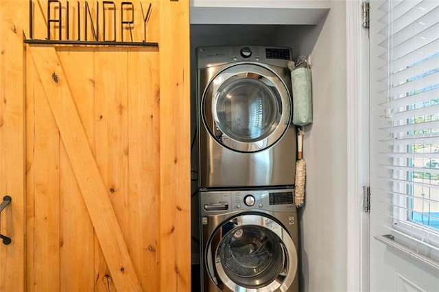 laundry area featuring stacked washer / dryer