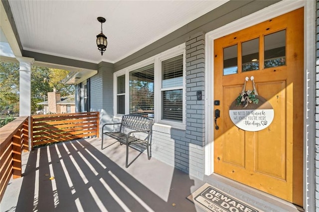 doorway to property featuring covered porch