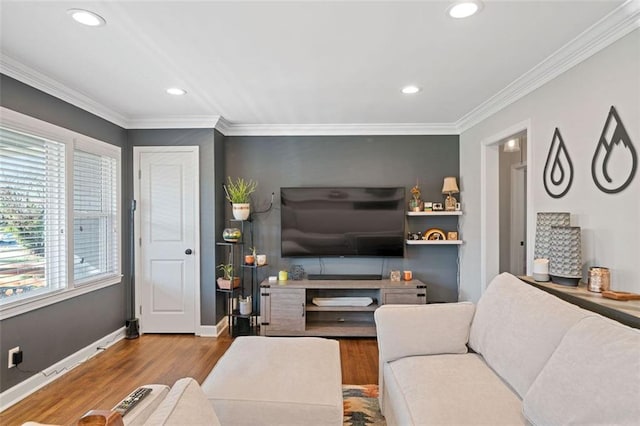 living room with hardwood / wood-style flooring and crown molding