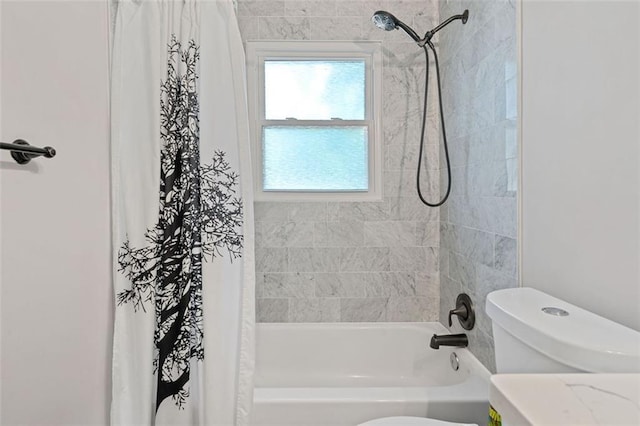 bathroom featuring shower / tub combo and toilet