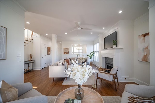 living room with crown molding, wood-type flooring, and a premium fireplace