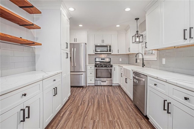 kitchen with open shelves, a sink, dark wood-type flooring, white cabinets, and appliances with stainless steel finishes