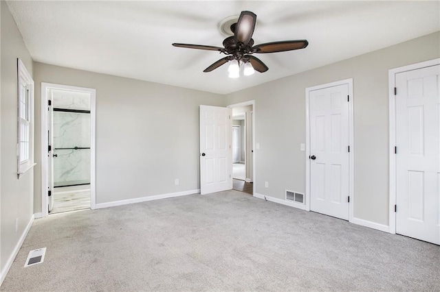 unfurnished bedroom featuring carpet, visible vents, and baseboards