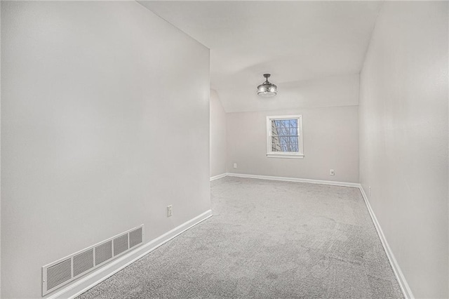 spare room with visible vents, baseboards, and carpet