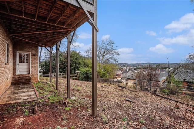 view of yard featuring fence and entry steps